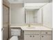 Bathroom featuring a vanity with sink, toilet, and shower with gold frame and glass doors at 510 Spring Lakes Blvd, Bradenton, FL 34210