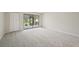 Bedroom featuring plush carpeting, closet, and sliding glass door to the outside at 510 Spring Lakes Blvd, Bradenton, FL 34210