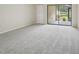 This bedroom has neutral carpet, closet, and sliding glass door leading to the porch at 510 Spring Lakes Blvd, Bradenton, FL 34210