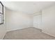 A sunny bedroom with neutral walls, neutral carpet, and a closet at 510 Spring Lakes Blvd, Bradenton, FL 34210