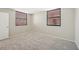 Bright bedroom featuring neutral walls, carpet, and windows with horizontal blinds for filtered natural light at 510 Spring Lakes Blvd, Bradenton, FL 34210
