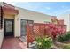 Charming condo featuring colorful foliage and decorative red lattice fencing around a private outdoor patio at 510 Spring Lakes Blvd, Bradenton, FL 34210