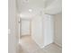 Well-lit hallway with tiled floor that features a closet for coats and storage at 510 Spring Lakes Blvd, Bradenton, FL 34210
