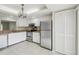 Bright kitchen with stainless steel appliances and plenty of white cabinet storage, great for cooking at 510 Spring Lakes Blvd, Bradenton, FL 34210