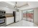 Efficient kitchen with stainless appliances and an open view to the patio through sliding glass doors at 510 Spring Lakes Blvd, Bradenton, FL 34210