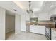 Well-lit kitchen with stainless steel appliances, white cabinets, and an eat-in dining area at 510 Spring Lakes Blvd, Bradenton, FL 34210