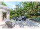 Backyard patio with a seating area surrounding a fire pit, great for relaxing at 5151 Jasmine Way, Palm Harbor, FL 34685