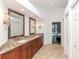 Beautiful bathroom featuring granite countertops and decorative lighting fixtures at 5151 Jasmine Way, Palm Harbor, FL 34685
