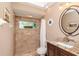 Bathroom featuring a tile shower and vanity with granite countertop at 5151 Jasmine Way, Palm Harbor, FL 34685