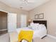 Bedroom with an upholstered headboard, bench, and soft decor at 5151 Jasmine Way, Palm Harbor, FL 34685