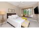 Bedroom with a large window, window seat, and comfortable furniture at 5151 Jasmine Way, Palm Harbor, FL 34685