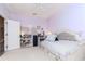 Bedroom with neutral color palette, cozy window nook, and tasteful décor creates an inviting and relaxing space at 5151 Jasmine Way, Palm Harbor, FL 34685