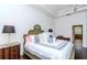 Stylishly decorated bedroom with a decorative headboard and tray ceiling at 5151 Jasmine Way, Palm Harbor, FL 34685