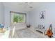 Bright bedroom featuring a window seat, ceiling fan, and neutral color scheme at 5151 Jasmine Way, Palm Harbor, FL 34685