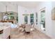 Cozy breakfast nook with a round table, chairs, and natural light pouring in from the adjacent windows at 5151 Jasmine Way, Palm Harbor, FL 34685