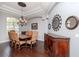 Elegant dining room featuring hardwood floors, a large chandelier, and sophisticated decor at 5151 Jasmine Way, Palm Harbor, FL 34685