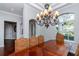 Formal dining room with stylish furnishings, a large chandelier, and plenty of space for entertaining at 5151 Jasmine Way, Palm Harbor, FL 34685