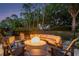 Backyard with fire pit, outdoor seating, and mature landscaping at 5151 Jasmine Way, Palm Harbor, FL 34685