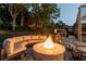 Outdoor fire pit with lounge area in a private backyard setting, with mature trees at 5151 Jasmine Way, Palm Harbor, FL 34685