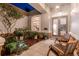 Charming front porch with stone accents, tiled floor, and inviting seating area at 5151 Jasmine Way, Palm Harbor, FL 34685