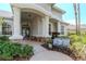 Inviting front porch featuring stone accents and a welcoming seating area at 5151 Jasmine Way, Palm Harbor, FL 34685