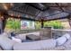 Outdoor gazebo with a projector screen, a grill, stainless steel drawers, and comfortable seating at 5151 Jasmine Way, Palm Harbor, FL 34685