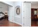 Hallway featuring an arched alcove and doorways leading to the bedroom and office spaces at 5151 Jasmine Way, Palm Harbor, FL 34685