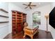 Luxurious office space with custom wood shelving, an elegant desk, and plenty of natural light at 5151 Jasmine Way, Palm Harbor, FL 34685
