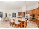 Spacious kitchen with wooden cabinetry, a large island with bar seating, and stainless steel appliances at 5151 Jasmine Way, Palm Harbor, FL 34685
