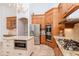 Kitchen boasts granite countertops, stainless steel appliances, and wood cabinetry at 5151 Jasmine Way, Palm Harbor, FL 34685