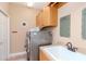 Functional laundry room featuring a utility sink and cabinet storage at 5151 Jasmine Way, Palm Harbor, FL 34685
