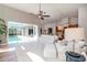 Bright living room featuring a high ceiling, ceiling fan, and access to a private pool at 5151 Jasmine Way, Palm Harbor, FL 34685