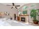 Spacious living room with a fireplace, large windows, and stylish decor and light-colored furnishing at 5151 Jasmine Way, Palm Harbor, FL 34685