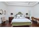 Inviting main bedroom with tray ceiling, hardwood floors, and ample natural light at 5151 Jasmine Way, Palm Harbor, FL 34685
