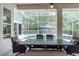 Covered patio with a dining table, comfortable seating and a pool view at 5151 Jasmine Way, Palm Harbor, FL 34685