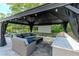 Outdoor covered gazebo with comfortable seating and grilling area. Perfect for entertaining at 5151 Jasmine Way, Palm Harbor, FL 34685