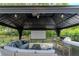 Outdoor covered gazebo with built-in grill, prep area, and comfortable seating for relaxation and entertainment at 5151 Jasmine Way, Palm Harbor, FL 34685
