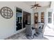 Covered patio features outdoor dining set, ceiling fan, and sliding glass doors leading indoors at 5151 Jasmine Way, Palm Harbor, FL 34685