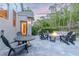 Outdoor patio with seating area, fire pit, and lush landscaping, with access to the yard at 5151 Jasmine Way, Palm Harbor, FL 34685
