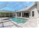 Screened-in pool with spa, updated deck, and adjacent patio, perfect for outdoor living and entertaining at 5151 Jasmine Way, Palm Harbor, FL 34685