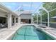 Beautiful backyard pool with screened enclosure, open patio, and seamlessly connected indoor living space at 5151 Jasmine Way, Palm Harbor, FL 34685