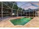 This property features a screened pool, spa, and gazebo with outdoor seating at 5151 Jasmine Way, Palm Harbor, FL 34685