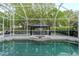 Relaxing screened pool features a spa and outdoor gazebo with comfortable seating at 5151 Jasmine Way, Palm Harbor, FL 34685