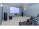 Movie theater-style room features tiered seating, projector, and screen at 5151 Jasmine Way, Palm Harbor, FL 34685