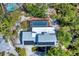 Birds-eye view of the property featuring the pool area, backyard, roof top solar panels, and brick firepit area at 5404 4Th Avenue Nw Dr, Bradenton, FL 34209