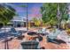 Enjoy a fire pit and relaxing Adirondack chairs in the home's backyard with screened in pool at 5404 4Th Avenue Nw Dr, Bradenton, FL 34209