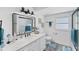 Bright bathroom with a double vanity, modern fixtures, and shower and tub combo at 5404 4Th Avenue Nw Dr, Bradenton, FL 34209