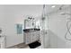 Bathroom featuring vanity with dark countertop and glass-enclosed shower with marble tile at 5404 4Th Avenue Nw Dr, Bradenton, FL 34209