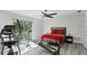 Bright bedroom with natural light, gray wood floors, and fitness equipment for an active lifestyle at 5404 4Th Avenue Nw Dr, Bradenton, FL 34209