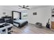 Bright bedroom featuring a murphy bed, desk, and sleek ceiling fan, offering a versatile space at 5404 4Th Avenue Nw Dr, Bradenton, FL 34209